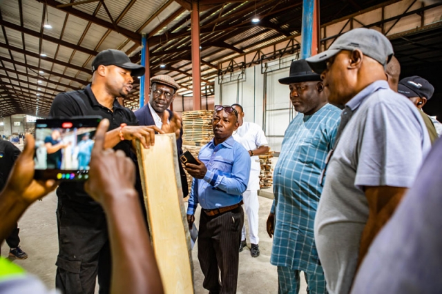 Site manager of Woodland Wood Factory making some explanations to Engr. Amechi and his team