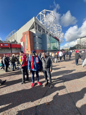 Chief Amechi visiting Old Trafford with friend 768x1024