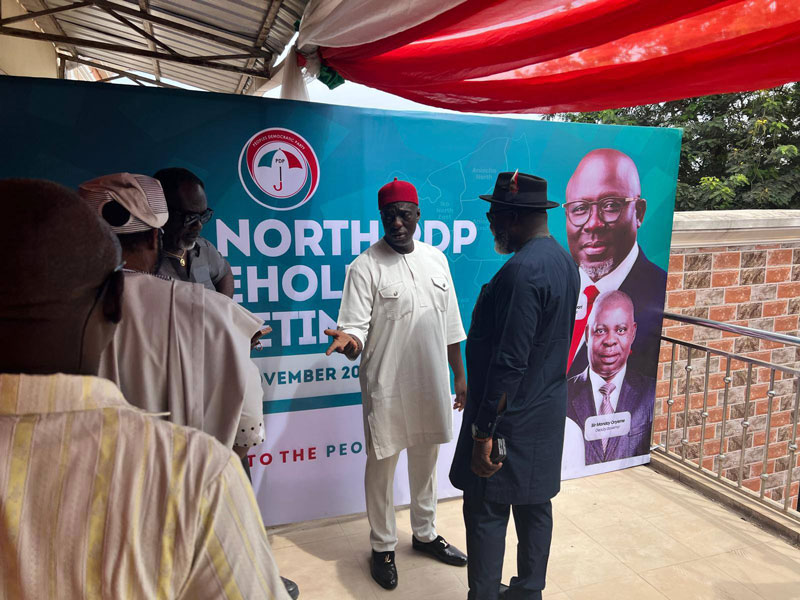 Chief Dan Ossai (in white and a red cap) making an explanation to Chief Tony Amechi (in blue attire with a hat)