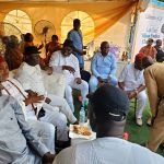 Chief Tony Amechi sitting with some guests at Chief Onah's burial
