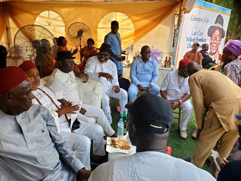 Chief Tony Amechi sitting with some guests at Chief Onah's burial